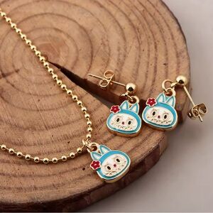 Gold Tone Monsters Labubu Inspired Blue Head Flower Necklace & Earrings Set